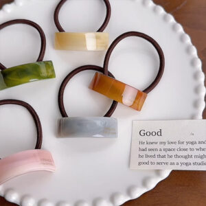 acetate hair tie detail with glossy decorative pieces and elastic cord