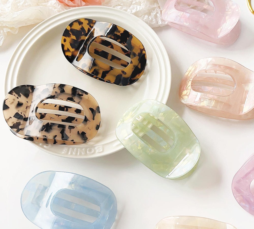 Acetate hair clips in different shapes and colours arranged as a coordinated retail collection